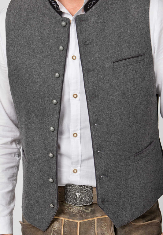 Gray vest over a white shirt with a belt buckle on a plain background