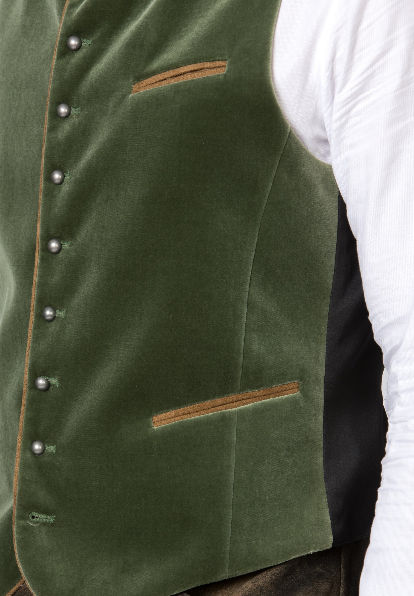 A close up view of a moss green trachten men's vest with silver round knob buttons, featuring contrasting suede piping and a short stand-up collar with filigree embroidery.