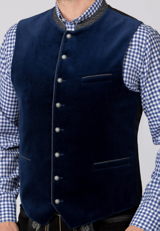 A close up view of a traditional indigo blue men's vest with a stand-up collar, three pockets, and silver round knob buttons.