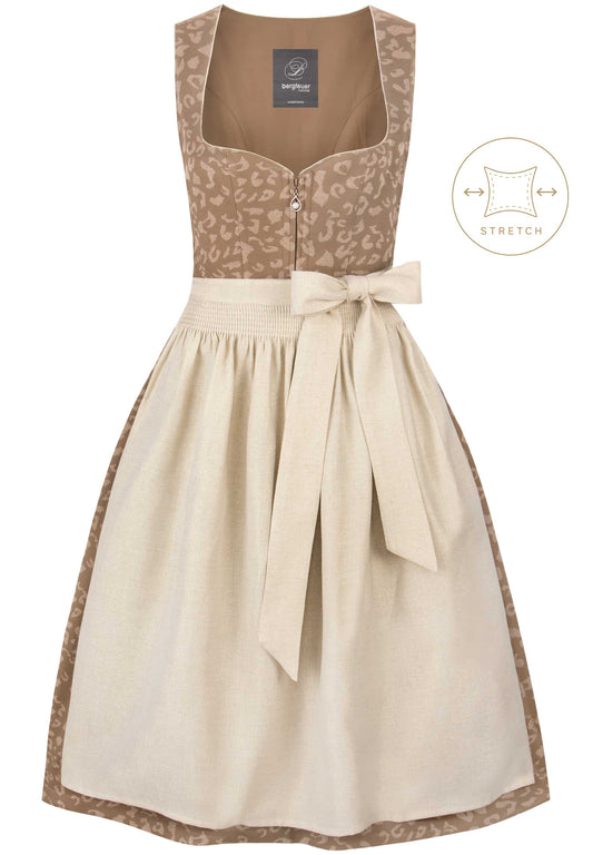 A sleeveless dirndl dress in beige and brown, featuring a leopard-print bodice, a cream linen skirt, and a matching fabric waist tie. A small brand label is visible inside the neckline, and a circular graphic overlay on the right indicates stretch functionality.