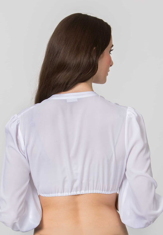 A woman viewed from the back wearing a white long-sleeve crop top with puffed sleeves, against a plain light gray studio background.