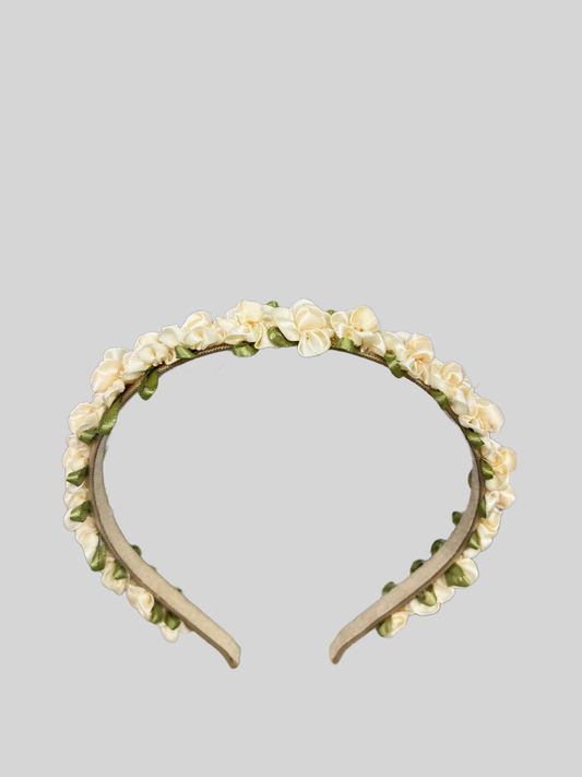 Floral headband with white flowers on a gray background