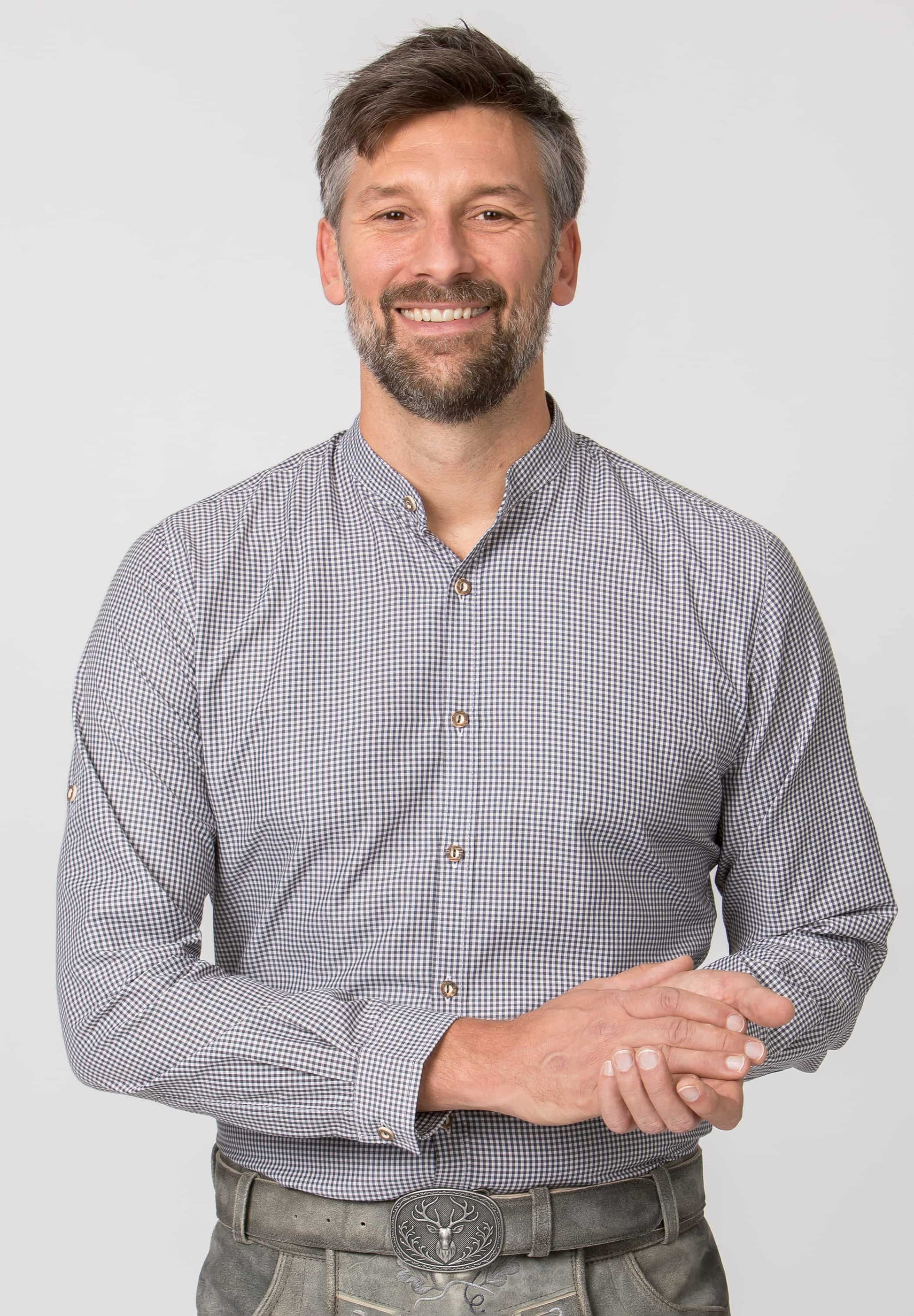 Man wearing a checkered shirt with a plain background