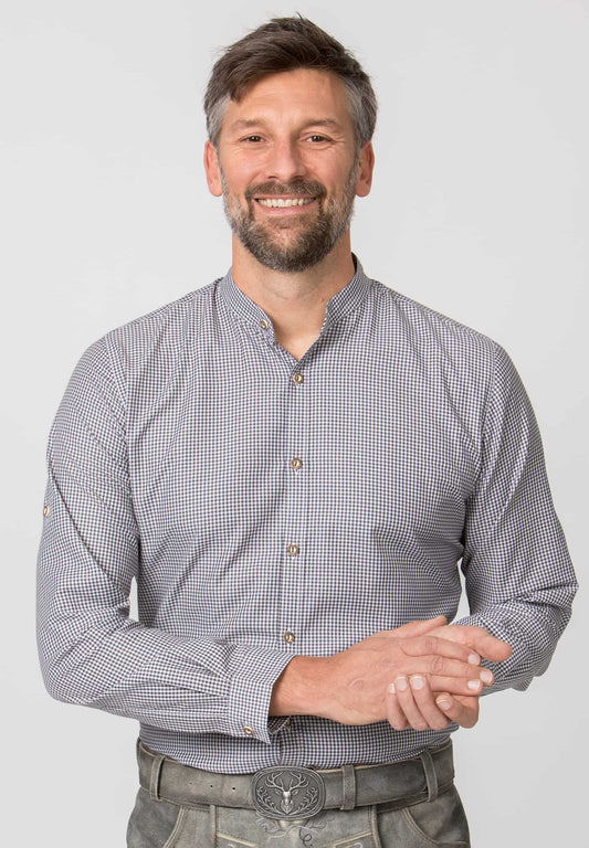 Man wearing a checkered shirt with a plain background