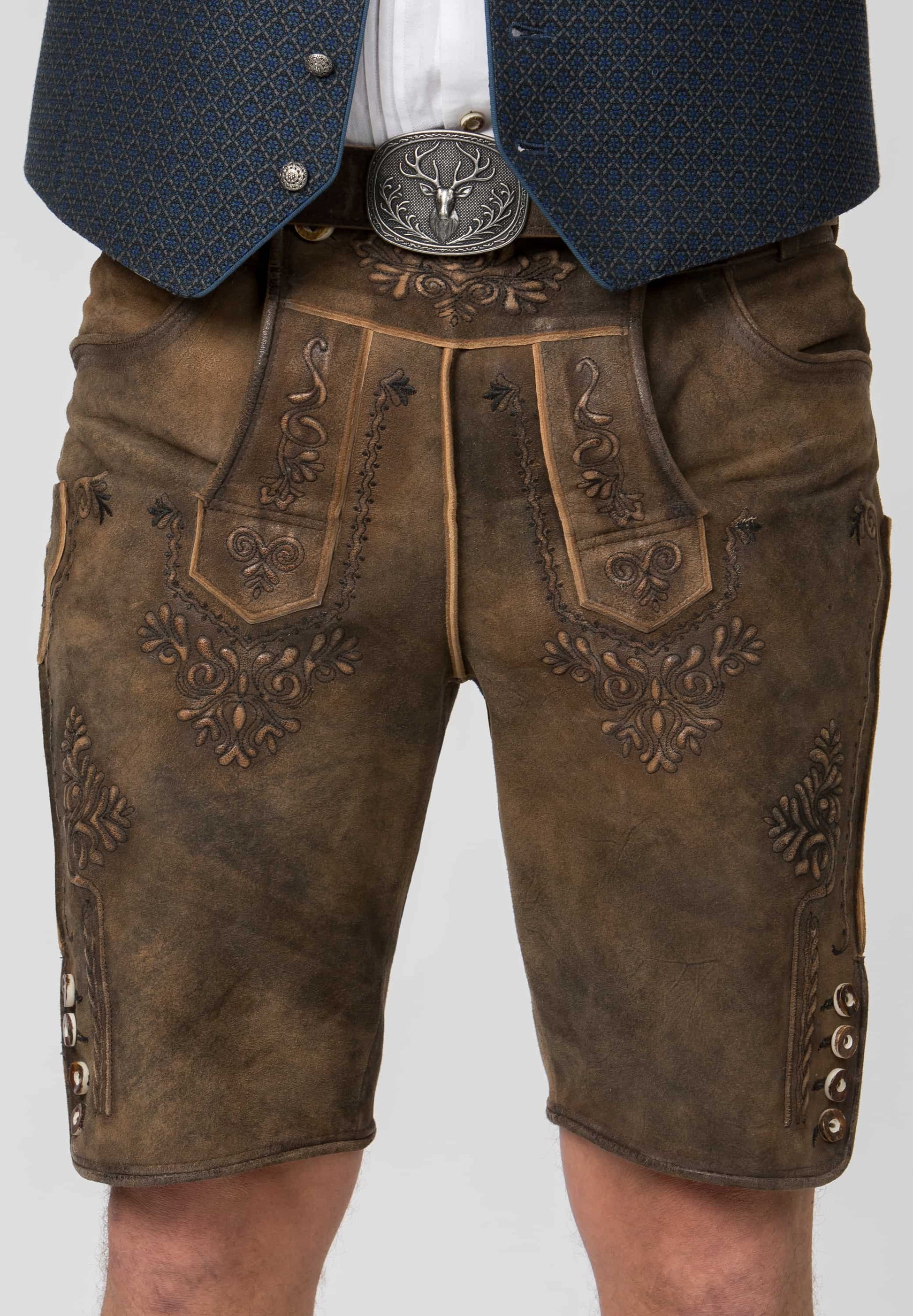 Brown leather shorts with intricate embroidery and a decorative belt on a plain background