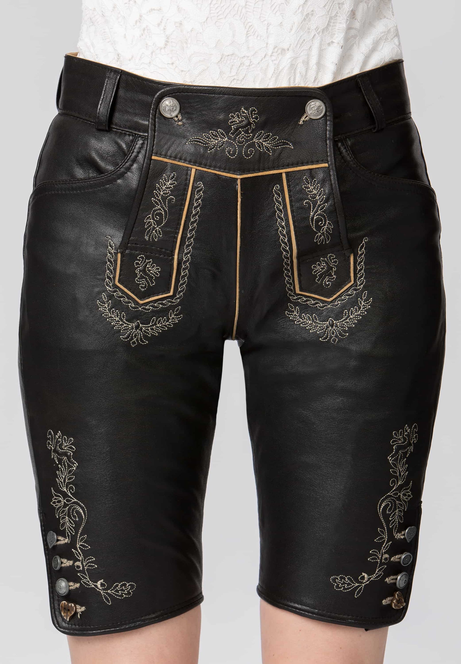 Black leather shorts with intricate gold embroidery on a white background