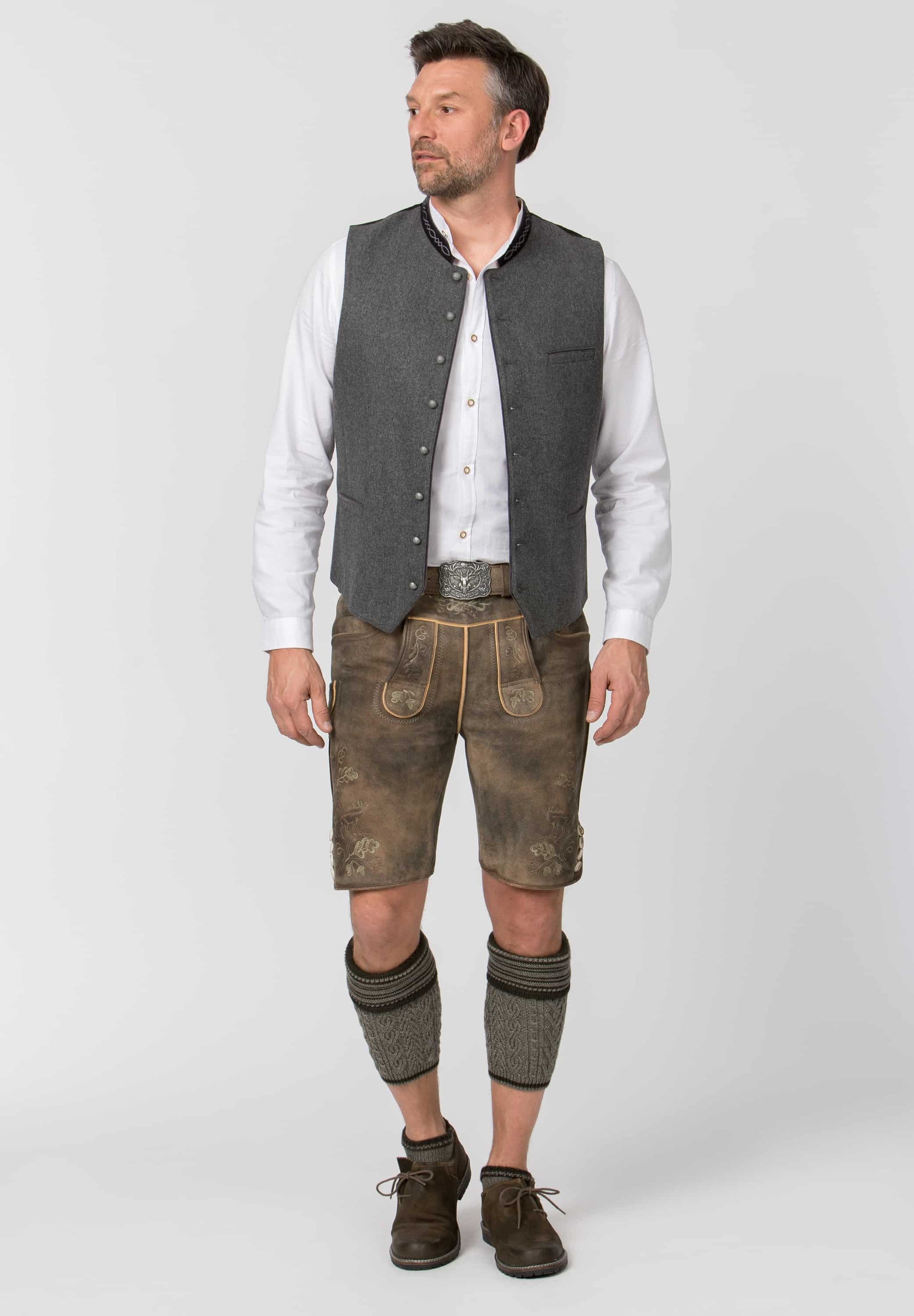 Man wearing traditional Bavarian clothing on a white background