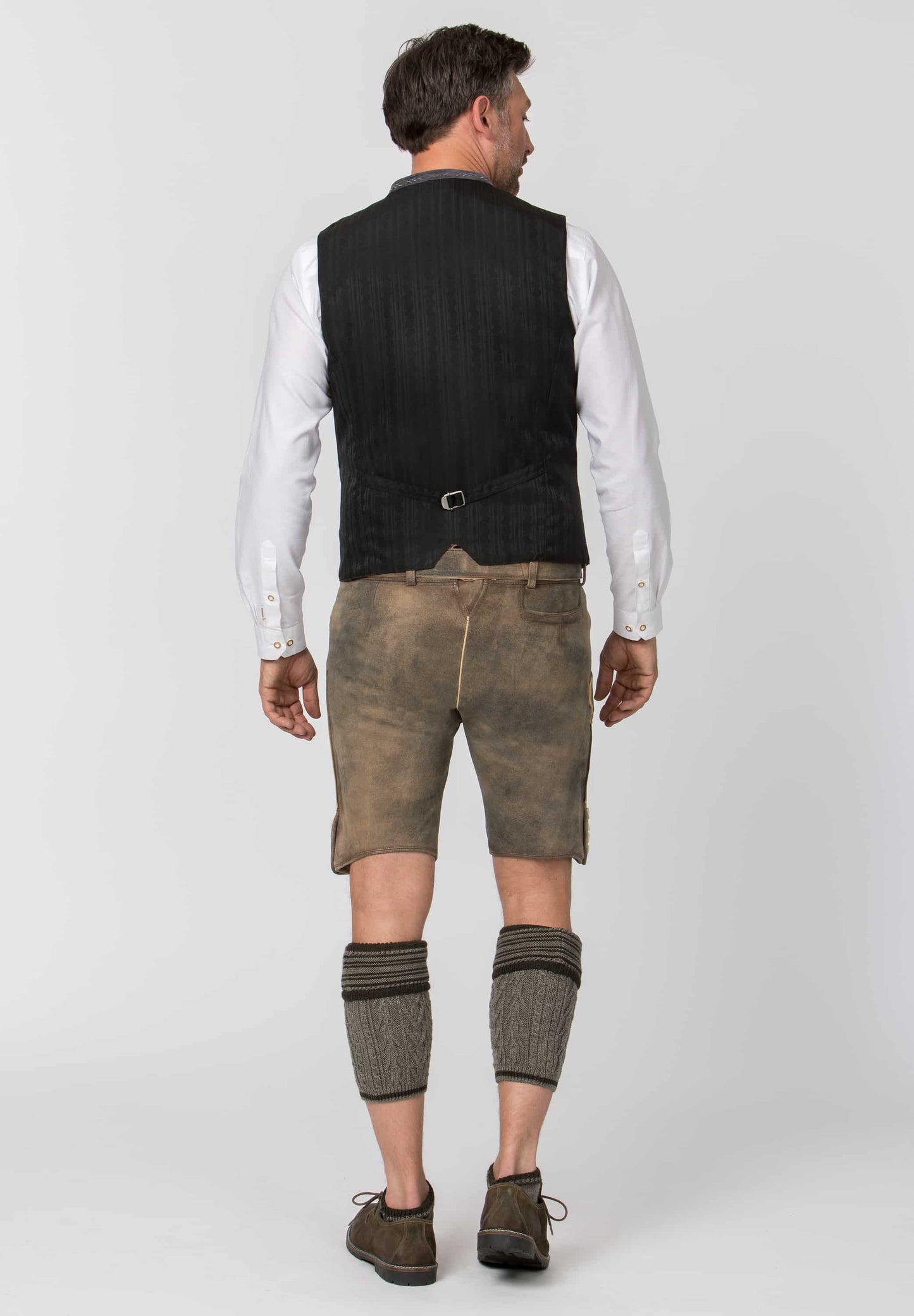 Man wearing traditional Bavarian clothing on a white background