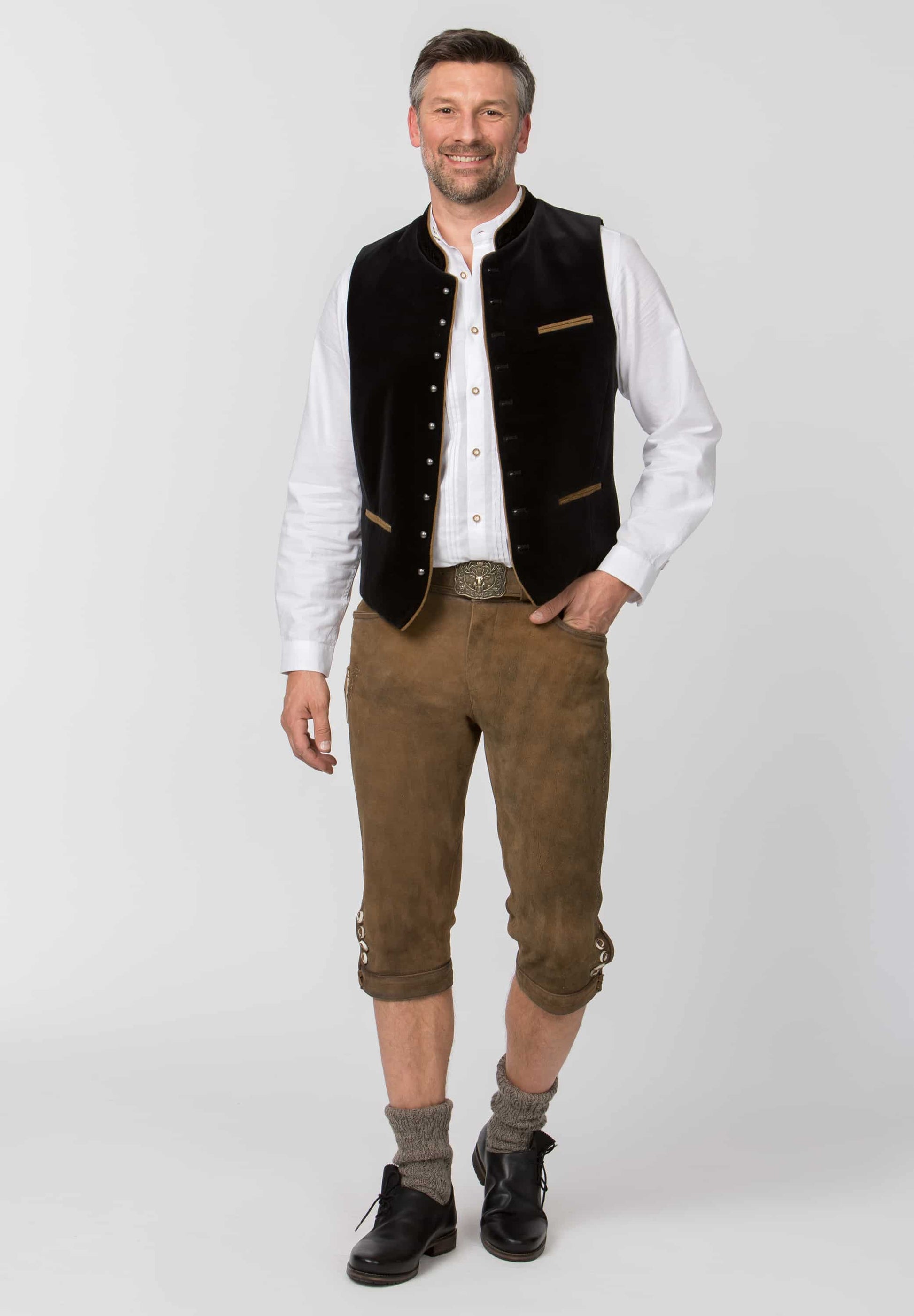 Man wearing traditional Bavarian clothing on a white background