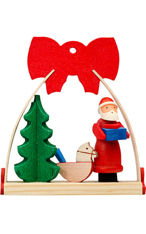 Santa Claus leaving toys near the tree